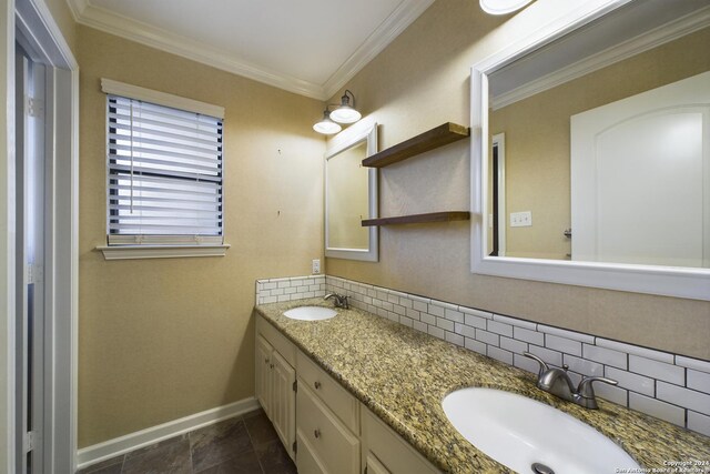 bathroom featuring vanity, crown molding, and tasteful backsplash