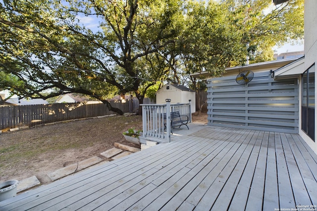 wooden terrace featuring a shed