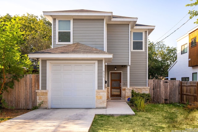 front facade featuring a garage and a front lawn