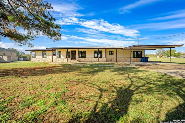 ranch-style home with a porch, a front yard, and a carport