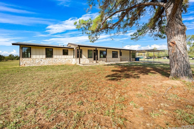 back of house featuring a yard and a carport