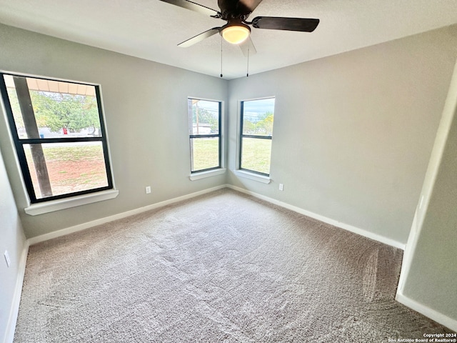 spare room with carpet and ceiling fan