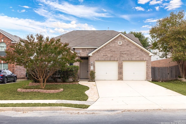 view of front of property with a garage and a front lawn