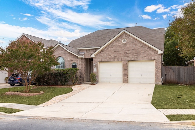 view of front of house featuring a garage and a front lawn