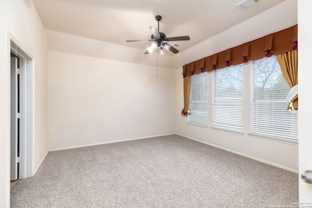 unfurnished room with ceiling fan and carpet