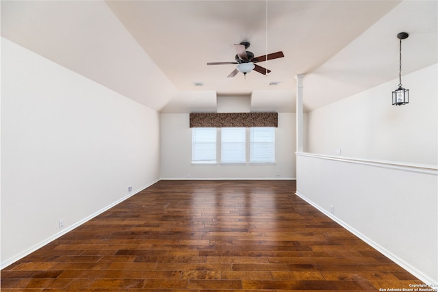 unfurnished room featuring dark hardwood / wood-style flooring, vaulted ceiling, and ceiling fan