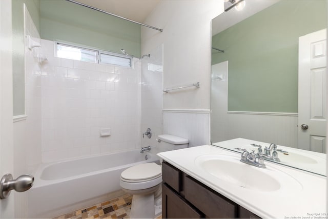 full bathroom with vanity, toilet, tiled shower / bath, and wood walls