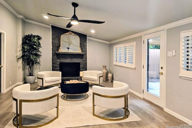 living room featuring wood-type flooring, ornamental molding, and a wealth of natural light