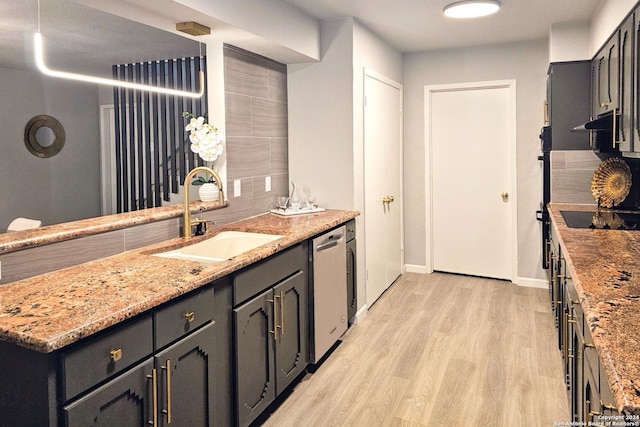 kitchen with dishwasher, black electric stovetop, sink, light hardwood / wood-style floors, and light stone counters