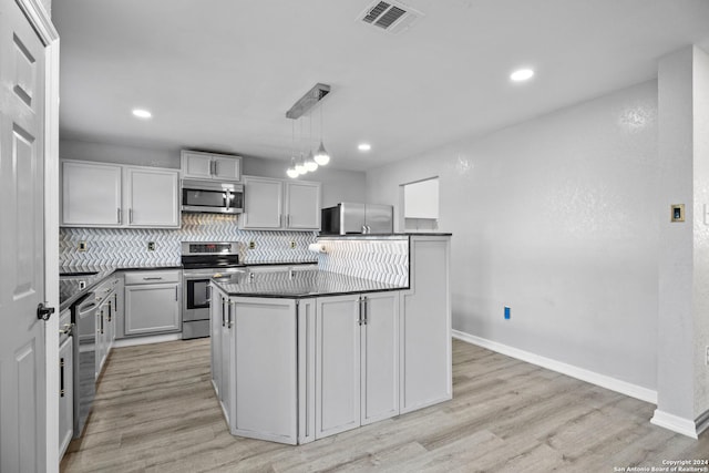 kitchen featuring decorative light fixtures, light wood-type flooring, stainless steel appliances, and gray cabinetry