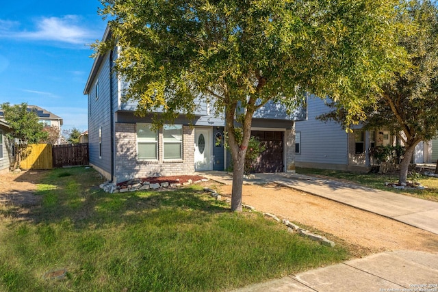 view of front of house with a front yard and a garage