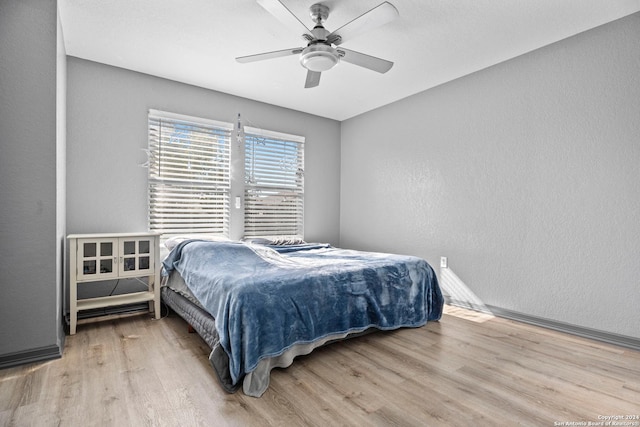 bedroom with ceiling fan and hardwood / wood-style floors