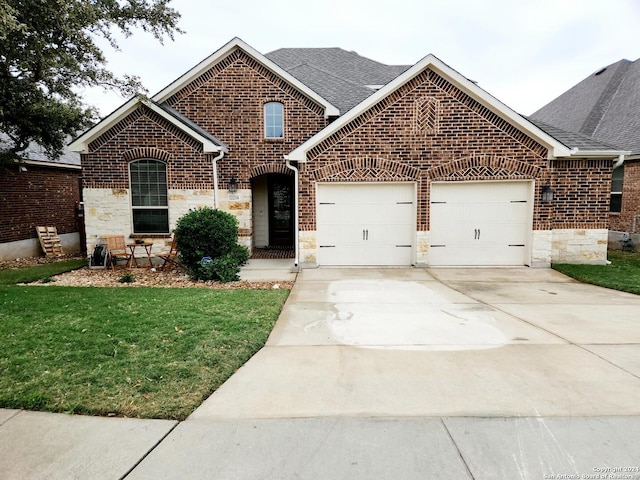 view of front facade featuring a garage and a front lawn