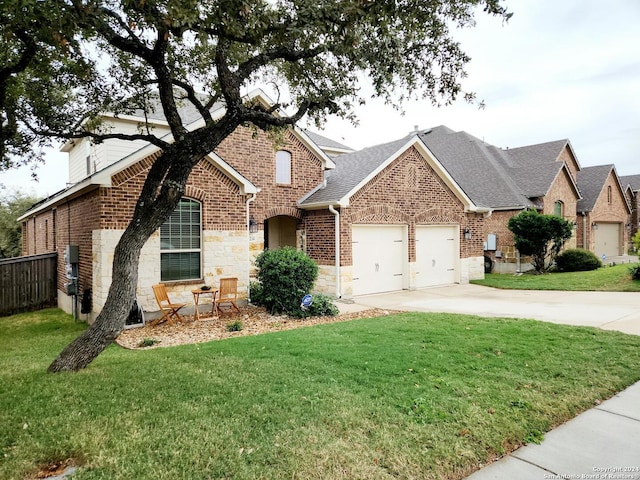 view of front of home featuring a garage and a front yard