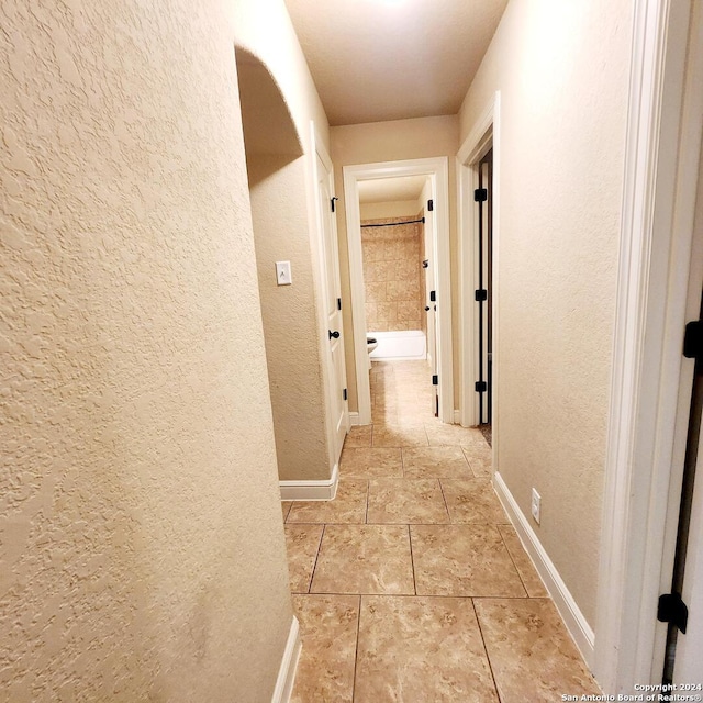 corridor with light tile patterned floors