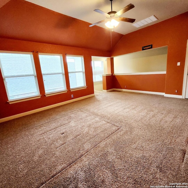 unfurnished room with ceiling fan, carpet floors, and lofted ceiling