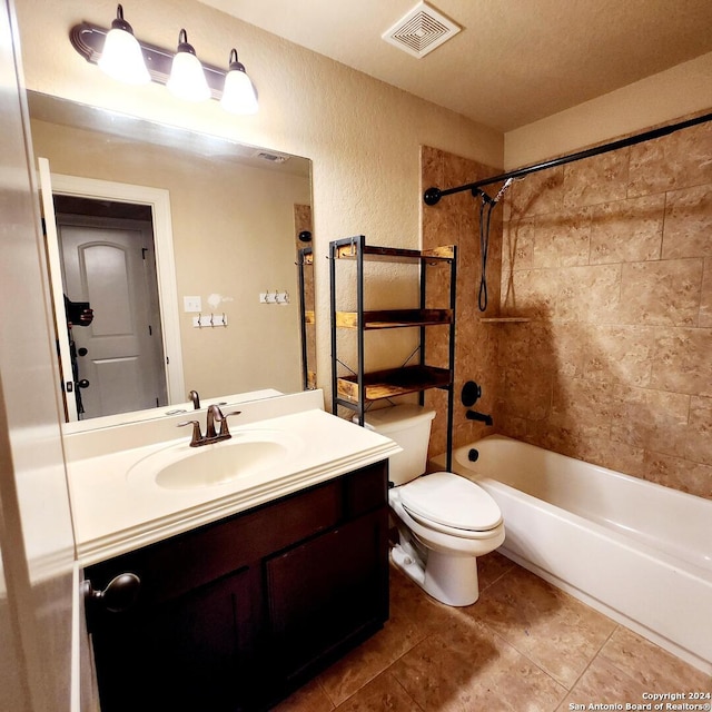 full bathroom with tile patterned floors, a textured ceiling, vanity, toilet, and tiled shower / bath