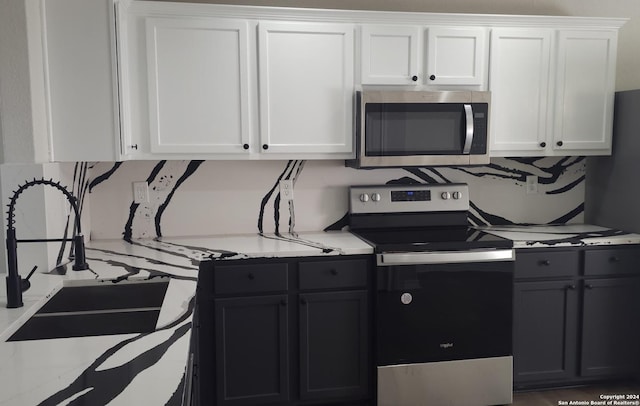 kitchen featuring sink, white cabinets, and stainless steel appliances