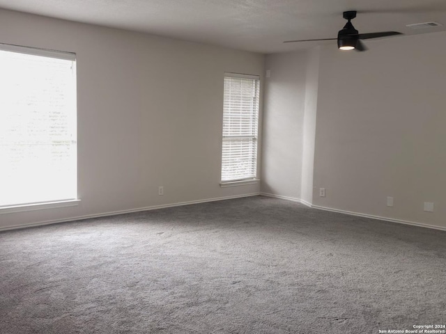 spare room featuring carpet floors and ceiling fan