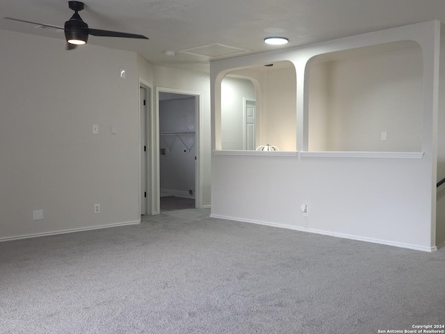 carpeted empty room featuring ceiling fan