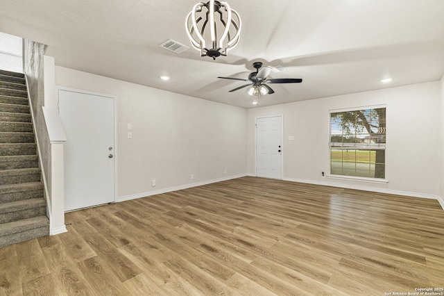 352 Solitaire Path, New Braunfels, TX 78130 - unfurnished living room with stairs, light wood finished floors, a ceiling fan, recessed lighting, and baseboards