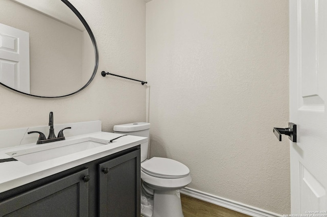 352 Solitaire Path, New Braunfels, TX 78130 - half bath featuring vanity, toilet, wood finished floors, and baseboards
