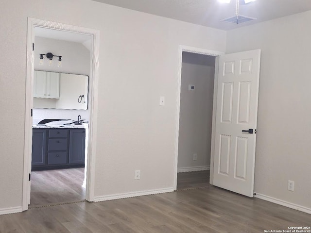 empty room with hardwood / wood-style floors