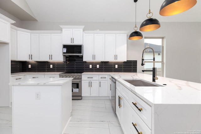 kitchen featuring white cabinets, sink, hanging light fixtures, and appliances with stainless steel finishes