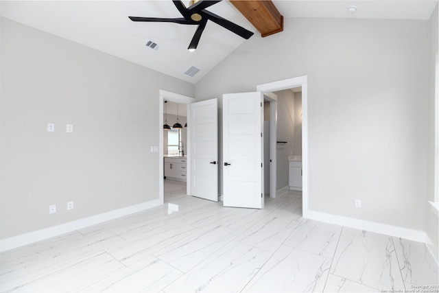 unfurnished bedroom featuring beam ceiling, ensuite bath, ceiling fan, sink, and high vaulted ceiling