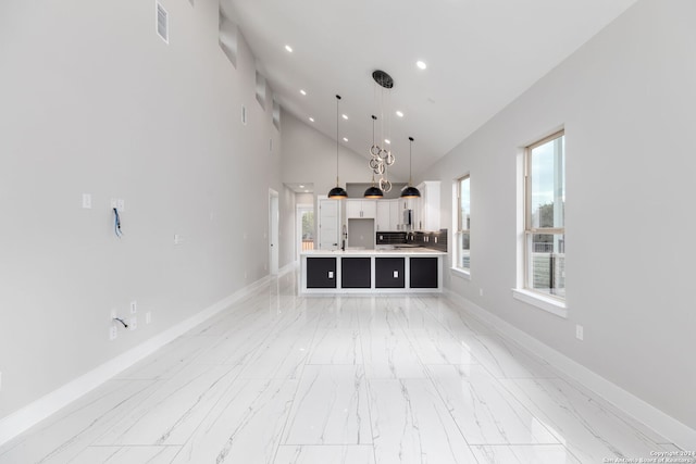 bathroom featuring high vaulted ceiling