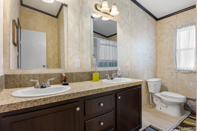 bathroom with wood-type flooring, vanity, toilet, and crown molding