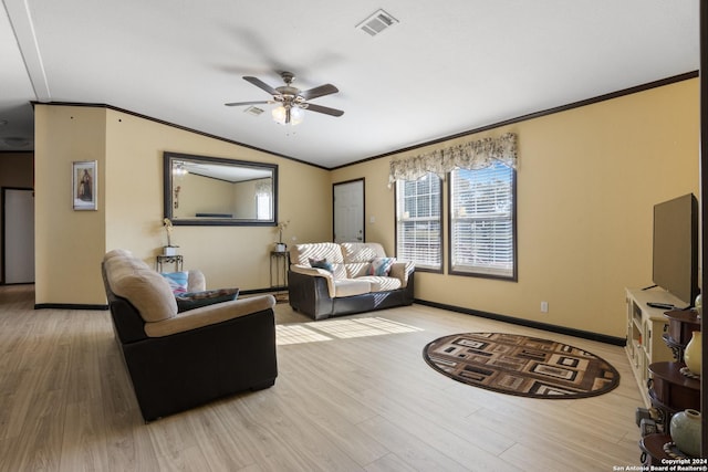 living room featuring ceiling fan, hardwood / wood-style floors, vaulted ceiling, and ornamental molding