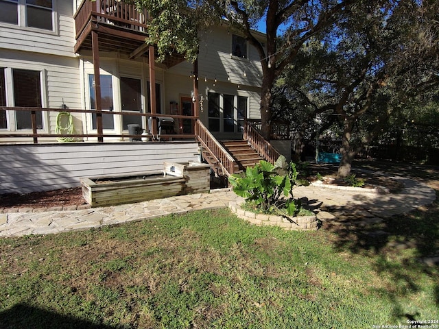 exterior space featuring a lawn and a deck