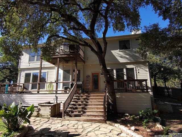 view of front of house featuring a balcony