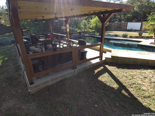 exterior space with a storage unit, ceiling fan, and a fenced in pool