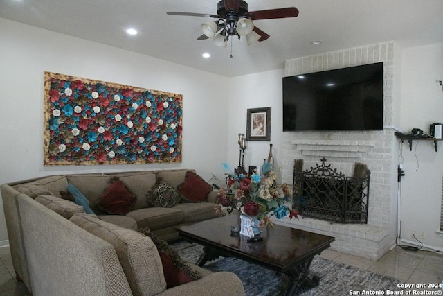 tiled living room with a brick fireplace and ceiling fan