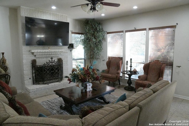 living room with a fireplace, ceiling fan, and light tile patterned flooring