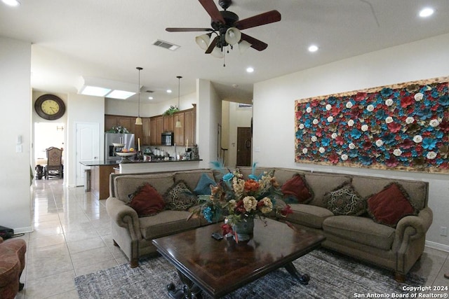 living room featuring ceiling fan and light tile patterned flooring