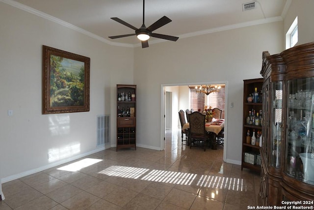 interior space with tile patterned flooring, a towering ceiling, ceiling fan with notable chandelier, and crown molding