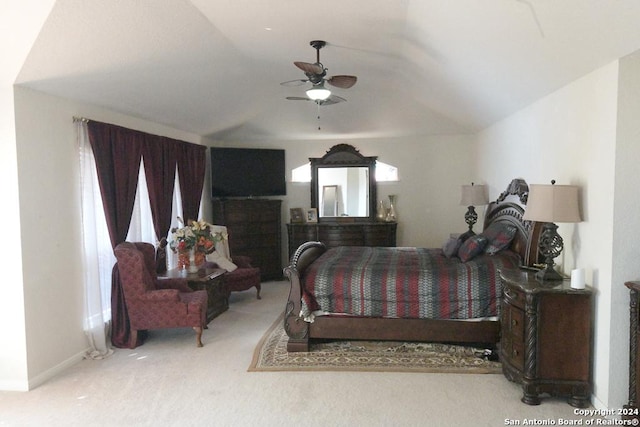 carpeted bedroom with a fireplace, ceiling fan, and lofted ceiling