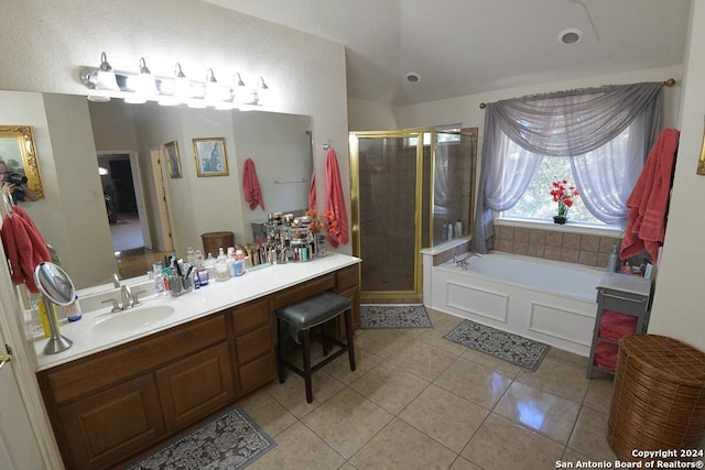 bathroom featuring tile patterned flooring, vanity, and shower with separate bathtub