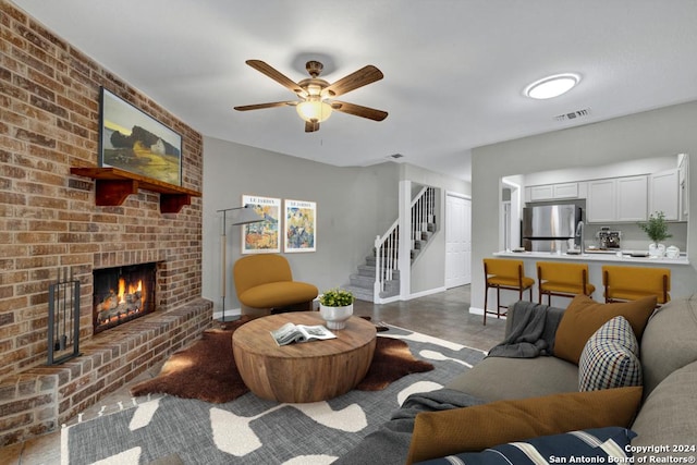 living room featuring ceiling fan and a fireplace