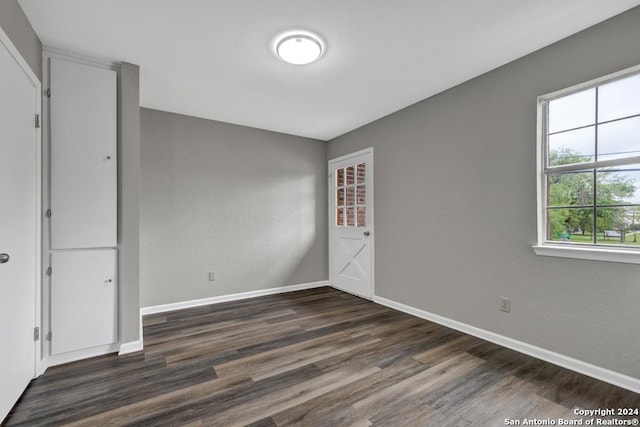 unfurnished bedroom featuring dark wood-type flooring