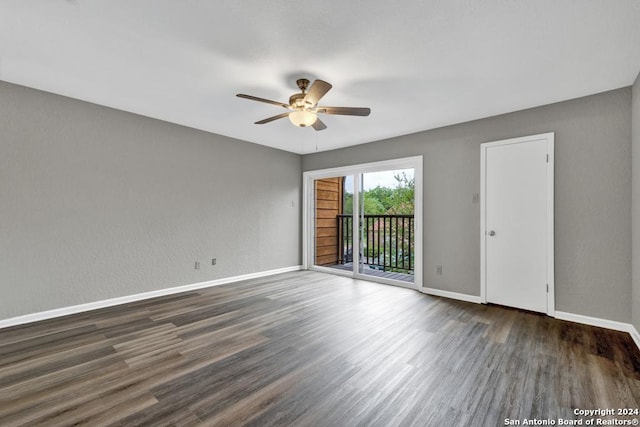 spare room with ceiling fan and dark wood-type flooring