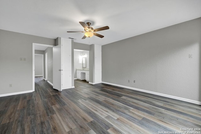 unfurnished bedroom featuring ensuite bathroom, ceiling fan, and dark hardwood / wood-style floors