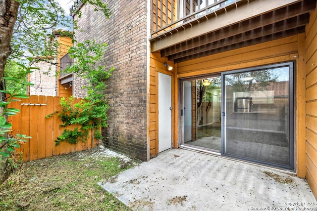 view of exterior entry featuring a patio area