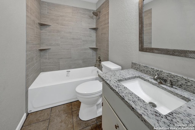 full bathroom with tiled shower / bath, tile patterned flooring, vanity, and toilet