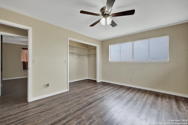 unfurnished bedroom with ceiling fan, dark wood-type flooring, and ornamental molding