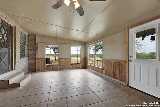 unfurnished sunroom featuring ceiling fan and lofted ceiling