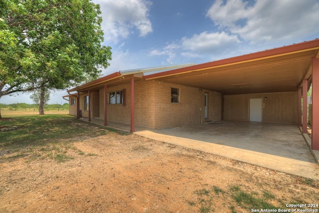 view of side of property featuring a carport